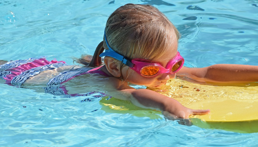 child with kick board