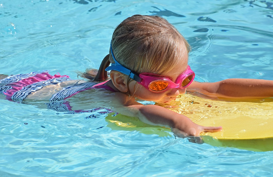 child with kick board